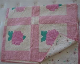 Antique quilt with rose applique