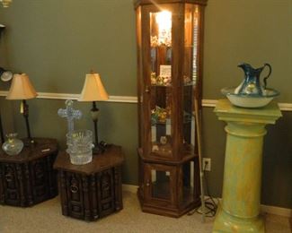 Curio cabinet containing small collection of Mood Dragons, pedestal, wash bowl and pitcher, lamps, crystal. 