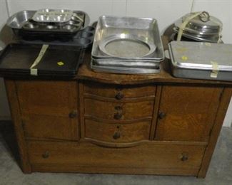 Vintage oak dresser base.  Cooking pans.