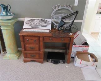 Small desk and metal signs.
