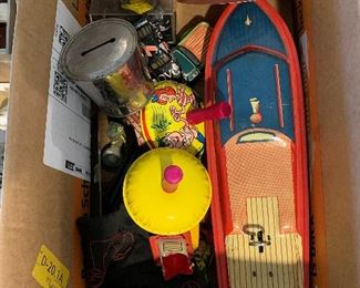 Box of old tin toys, cars and such.
