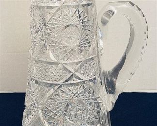 $50     33/ Crystal cut tall pitcher (chip by neck)  •  12high 9across