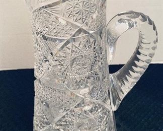 $50     33/ Crystal cut tall pitcher (chip by neck)  •  12high 9across