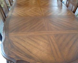 close-up of dining table, includes two leaves at 16 1/2" each.  Without leaves 6 feet long.  With leaves 102" long. 44" wide.  