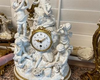 A serves white bisque porcelain and enamel striking clock in the form of a rook with 5 cupids in a pastoral setting CROSNIER A Paris Circa 1870