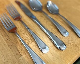 Two sets of Oneida stainless flatware … multiple place settings.