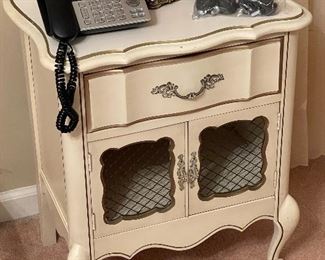 Thomasville Furniture Mid-century French Provincial Off-White Painted Nightstand (1962); Neutral color with solid wood frame and brass hardware. Features one dovetail drawer and lower cabinet with double brass mesh door fronts.