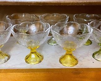 Vintage Depression Glass Ice Cream Dessert Bowls Dessert With Yellow flared stems, olive colored stems and clear stems. Measurements: 5" tall and 5" wide. A dot design embossed on the top.