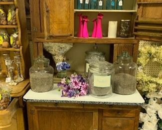 Antique Hoosier cabinet with porcelain top, large glassJars with lavender, lots of flower vases