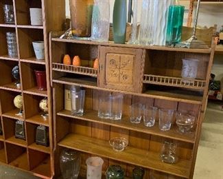 Antique book case with carved door. Large assortment of flower vases.