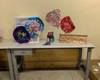 Heavy duty workbenches, Mylar balloons, large rolls of Christmas wrap and wrapping paper holders holders