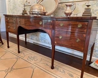Antique English George III Inlaid Mahogany Serpentine Front Sideboard with Brass Rail. Circa 1790. Straight Tapered Legs Ending in Spade Feet. Photo 1 of 6.