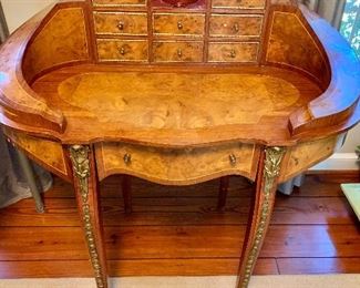 $495 - Burlwood, inlaid desk with ormolu detail - AS IS - missing one tiny piece of laminate on left side - 41" H, 42" W, 24" D.