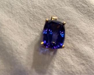 Tanzenite: 30.88kt  set in 14kt yellow gold. Violet-blue in color, cushion, 19.90 x 14.63x 1.72 . Amazing stone!! Have COA from Diamonds International. $22,500. If interested let me know ahead of time so I can retrieve from Bank vault. 