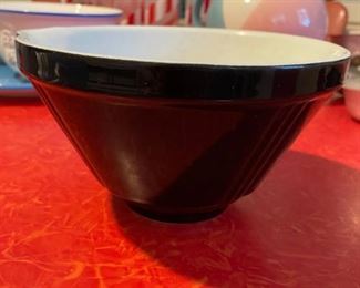 Black ceramic mixing bowl on top of red/chrome 1950’s diner table