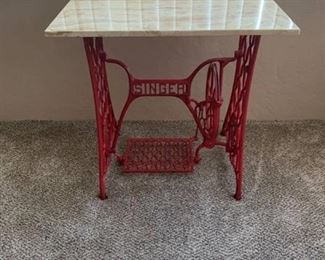 Singer treadle with stone top in basement