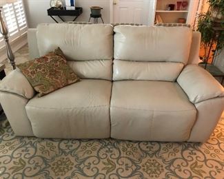 Beautiful Ashley Furniture electric couch. Each side reclines. Cream color leather.  Hugs the wall. Very comfortable.
