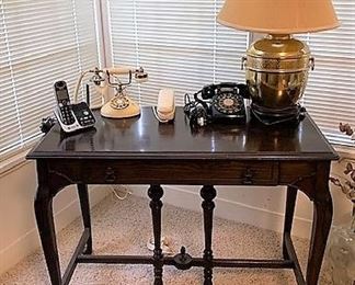 Desk, vintage phones, and brass ginger jar lamp