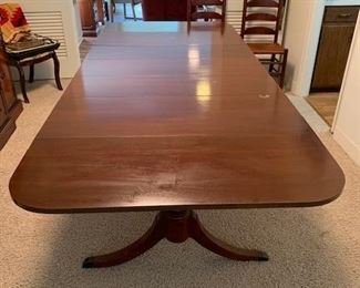 Triple-pedestal drop-leaf Duncan Phyfe table. When the table is fully extended with the drop-leaves up and the 3 additional leaves it is 99" long and 42" wide. 