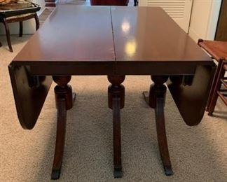 When the leaves are down and the 3 additional leaves are removed the table is about 33" long - no chairs