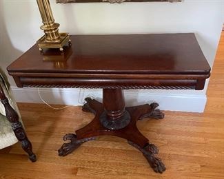 Antique mahogany game table w/carved pedestal, hairy paw & acanthus leaf feet, top swivels to open and unfold into square table or top can flip up against wall, New York origin, early 19th century.