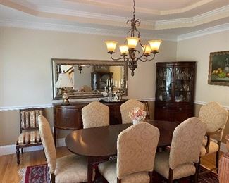 Dining Room: antique mahogany table with 4 leaves, pads and storage, sides drop to fit against wall, if wanted; set of 6 newly upholstered dining chairs, 1 captain’s chair, 1930s; mahogany bow front sideboard or server, inlays; (matching mahogany corner china cabinet, SOLD); pair of antique upholstered Eastlake side chairs (striped brocade fabric), gilded glass table lamp w/silk shade; oil on canvas still life; gorgeous antique Oriental area, 9 x 12’ rug.