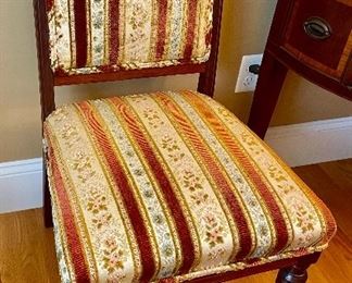 One of a pair of Aesthetic Period side-chairs w/ original striped upholstery. 