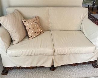 19th century reupholstered loveseat w/French blue floral fabric, carved feet & apron, new neutral slipcover; decorative pillows (sold separately).