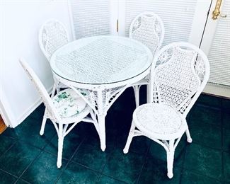 ROUND WICKER TABLE AND 4 CHAIRS. 
GLASS TOP.   36” wide.  $250