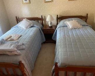 Twin Maple beds with mattresses and bedding 