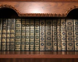 Large collection of leather bound books with gold leaf edge