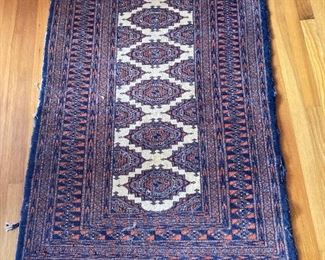 One of several wool Persian rugs - deep blue, cream and crimson