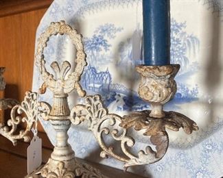 Transferware platter behind an iron double candlestick