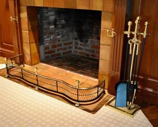 Brass and black metal fender and fireplace tools