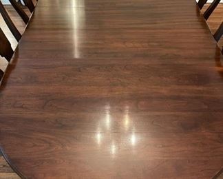 Formal dining table with three 10” leaves.  Table goes from 54” to 84” and is 42” deep.  Includes two captains chairs and four side chairs