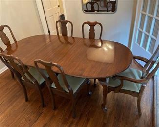Formal dining table with three 10” leaves.  Table goes from 54” to 84” and is 42” deep.  Includes two captains chairs and four side chairs