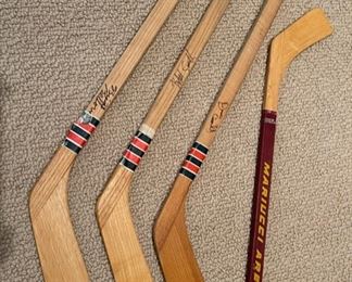 Vintage Cooper mini wood souvenir hockey sticks, signed, and a mini U of M Mariucci Arena souvenir hockey stick