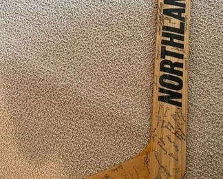 Vintage Northland hockey sticks, including one signed by staff and players as a retirement gift
