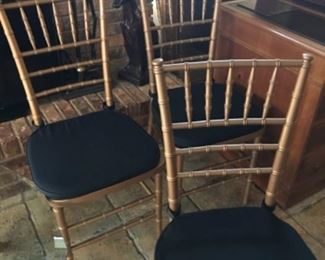 6 wood, faux bamboo chairs, painted gold, each has a black seat cushion.  $600 NOW $300 all 6