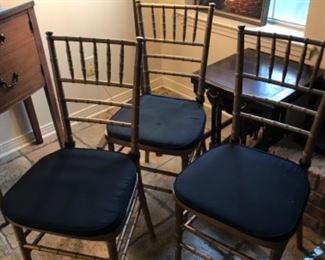 6 wood, faux bamboo chairs, painted gold, each has a black seat cushion.  NOW $300 all 6