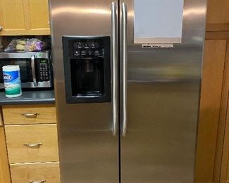 GE Stainless Steel Refrigerator side by side with ice and water in the door