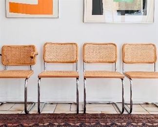 Andreas Brandt  prints on the left. Louise Nevelson collage on the right. Breuer-style cane dining chairs.