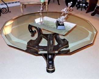 Lacquered wood dolphin cocktail table, beveled glass top