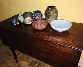 19th century drop leaf table featuring  Native American pottery and  featuring a Pre Columbian Colima pot from the West Coast of Mexico in the squash or peyote button form (often used in rituals practiced by Shamans)
