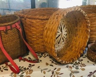 Early handwoven baskets including baskets to hold produce  and also a very early basket to strap on your back 