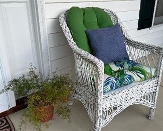 Wicker outdoor chair, potted plants 