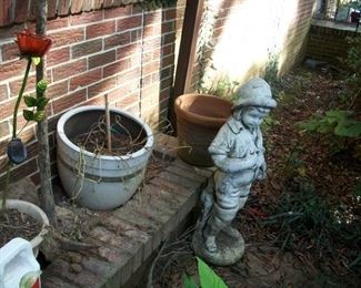 concrete boy, the little girl is hiding behind the plants