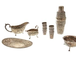 1022
A Group Of Sterling Silver Repoussé Table Items
19th/20th Century
Each marked for sterling, with various maker's marks
Comprising a Chinese export cocktail shaker (10" H x 3.5" Dia.), an American gravy boat (4.375" H x 8.75" W x 4.375" D) with dish (1" H x 9.75" W x 6" D), an Irish creamer (3.75" H x 5.75" W x 3.5" D) and sugar dish (2.625" H x 4.75" Dia.), and six shot glasses (each: 2.5" H x 1.75" Dia.), 11 pieces
55.07 oz. troy approximately
Estimate: $600 - $900
