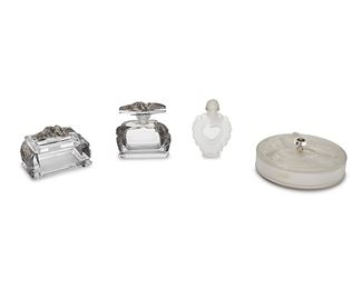 1026
A Group Of Art Glass Vanity Items
20th Century
One signed: Verlys; One signed: Bottle Made by Lalique France / Coeur Joie / Nina Ricci
Comprising a clear and frosted glass Verlys powder box with butterflies, a clear glass perfume bottle and lidded box with black tinted floral designs, and a clear and frosted glass Lalique "Coeur Joie" for Nina Ricci heart-shaped perfume bottle, 4 pieces
Larger: 4.25" H x 4.25" W x 1.75" D; Smaller: 3" H x 5" W x 2.875" D
Estimate: $200 - $400