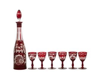 1030
A Bohemian Art Glass Liqueur Set
First-quarter 20th Century
The burgundy to clear glass with engraved motifs, comprising a decanter and six stems, 7 pieces
Decanter: 15.875" H x 3.5" Dia.; Each stem: 4.325" H x 2.5" Dia.
Estimate: $200 - $400